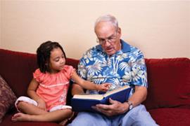 Grandad reading to child